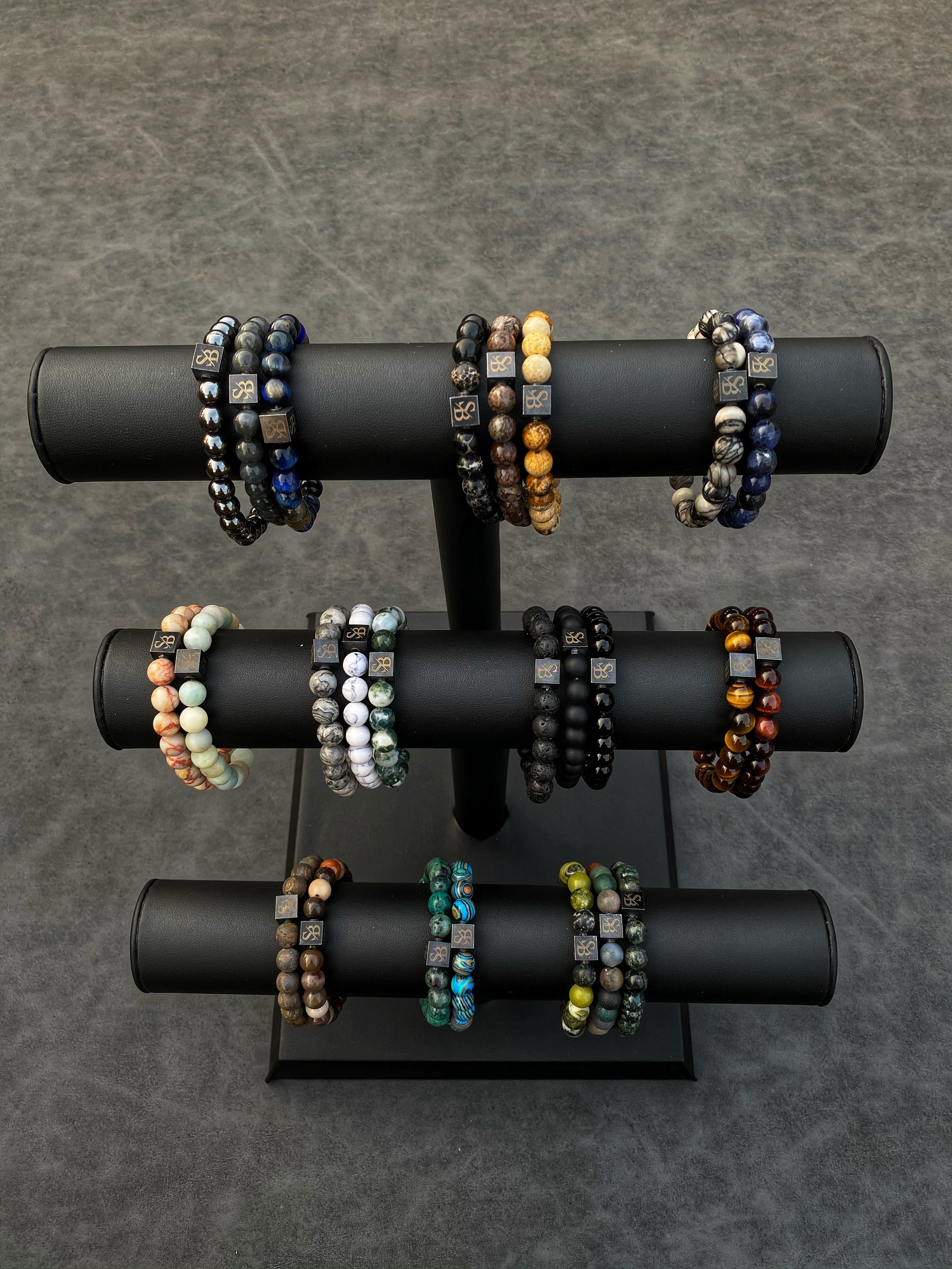 Een display van armbanden op een zwarte standaard.